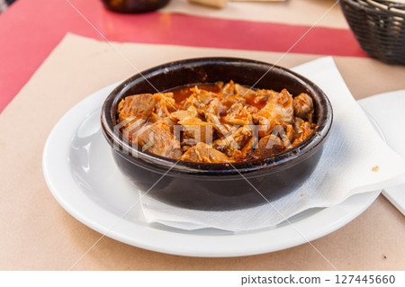 Stewed chicken gizzards in a sauce in a bowl on the table. Typical Spanish appetizer Stewed chicken gizzards in a sauce in a bowl on the table. Typical Spanish appetizer 127445660