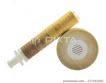 Old, dirty, and well-used water filter set against a white background 127445895