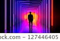A man in a suit walking through a tunnel of neon lights 127446405
