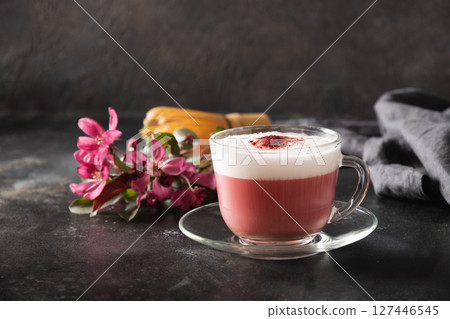 Pink matcha latte with powder decorated sakura flowers on dark black background. Trendy beverage. Caffeine free. Close up. 127446545