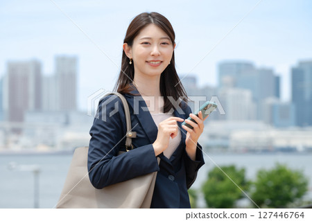 Business woman with smartphone Business woman with smartphone 127446764