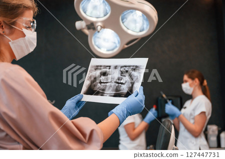 Woman is woking in the stomatological cabinet Woman is woking in the stomatological cabinet 127447731