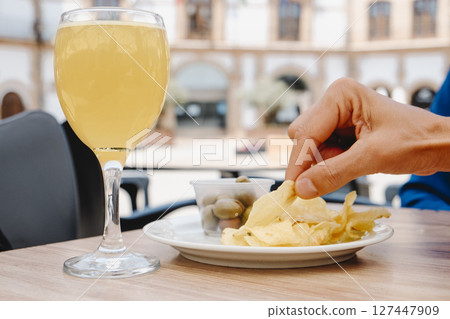 man about to eat a potato chip at an outdoor table 127447909