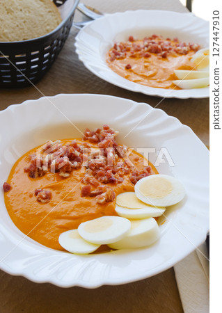 plates with spanish salmorejo on a table 127447910