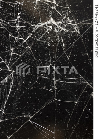 broken glass on a black background, glass broken into many pieces broken glass on a black background, glass broken into many pieces 127448241