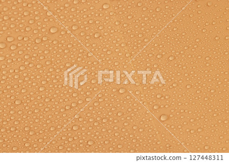a smooth surface of pale orange color covered with water droplets, a beautiful wet orange film in a large number of water droplets 127448311