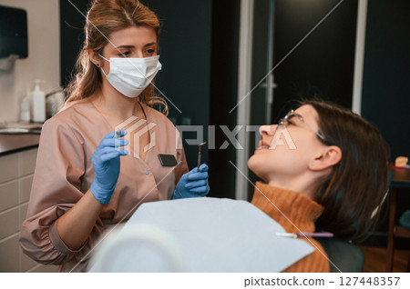 Young woman is in the chair. In the stomatological cabinet Young woman is in the chair. In the stomatological cabinet 127448357