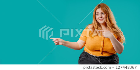 Recommending Smiling Body Positive Woman Pointing, Copy Space Or Advertising. Recommending Smiling Body Positive Woman Pointing, Copy Space Or Advertising. 127448367