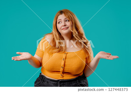 Plus size confused woman shrugging, cant help, makes unsure gesture of dont know Plus size confused woman shrugging, cant help, makes unsure gesture of dont know 127448373