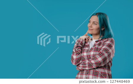 Thinking around woman, blue hair on studio background. Smart lady finding answer 127448469