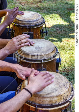 Various drums being played 127448977