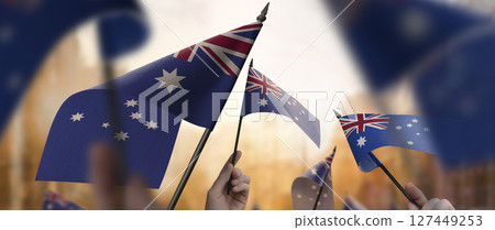 Australia flags in their hands on a blurred urban background Australia flags in their hands on a blurred urban background 127449253