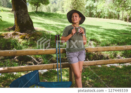 Woman Enjoying Outdoor Relaxation in a Scenic Natural Setting with Gear 127449339