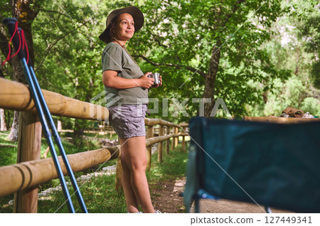 Woman Enjoying Outdoor Leisure Amidst Lush Greenery and Nature Woman Enjoying Outdoor Leisure Amidst Lush Greenery and Nature 127449341