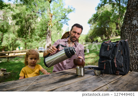 Father and Child Enjoying Outdoor Time in a Scenic Park Setting With Nature Surrounding Father and Child Enjoying Outdoor Time in a Scenic Park Setting With Nature Surrounding 127449401