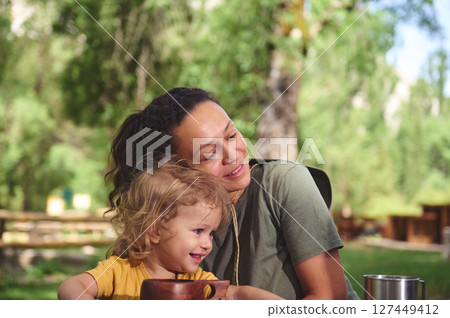 Mother and Toddler Enjoying Outdoor Quality Time at a Scenic Park 127449412