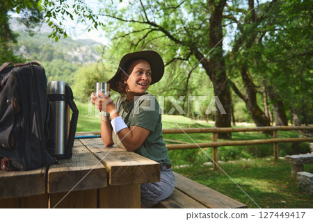 Woman Enjoying Outdoor Camp in Scenic Wooded Area 127449417