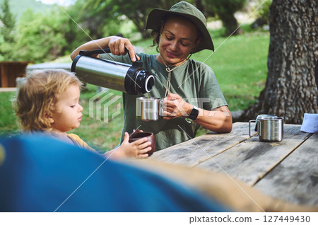 Family Enjoying Outdoor Camping With Warm Drinks and Nature 127449430