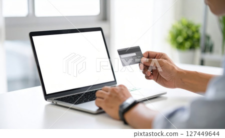 人工智慧圖像:一名男子使用信用卡線上購物 人工智慧圖像:一名男子使用信用卡線上購物 127449644