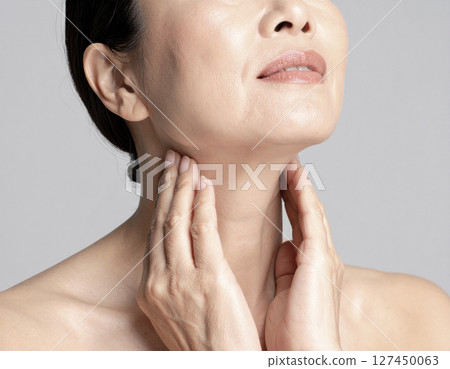 A Japanese woman in her 40s working on anti-aging care for her neck A Japanese woman in her 40s working on anti-aging care for her neck 127450063