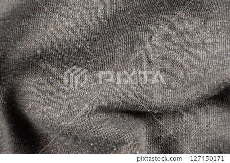 Macro texture of gray fabric with lots of pilling and damage on the surface. Macro texture of gray fabric with lots of pilling and damage on the surface. 127450171