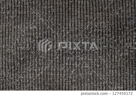 Macro texture of gray fabric with lots of pilling and damage on the surface. Macro texture of gray fabric with lots of pilling and damage on the surface. 127450172