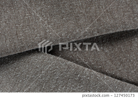 Macro texture of gray fabric with lots of pilling and damage on the surface. 127450173