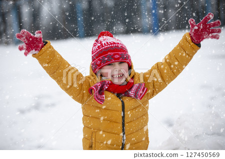 Child in winter. Happy boy in bright clothes on a winter day. Child in winter. Happy boy in bright clothes on a winter day. 127450569