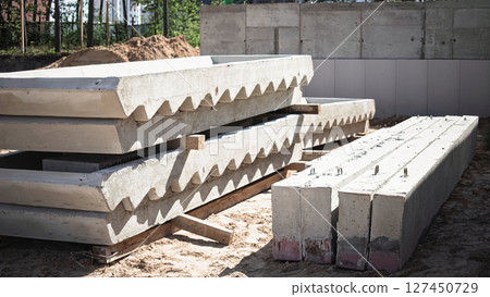 Construction site shows stacked concrete slabs in preparation for building foundations and structures Construction site shows stacked concrete slabs in preparation for building foundations and structures 127450729