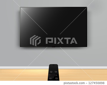 Watching smart tv with remote control. Remote control is pointed at the tv on the wall. 127450898