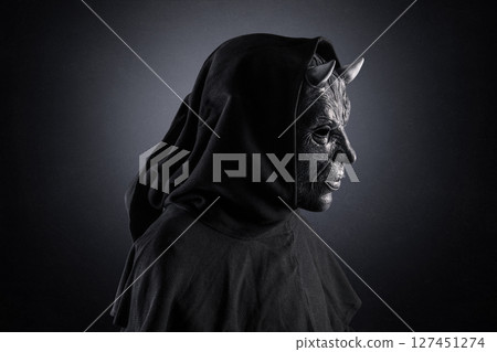 Portrait of a bad devil with horns on head over dark misty background 127451274