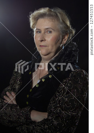 Elderly ugly woman with an evil face on a black background. Elderly ugly woman with an evil face on a black background. 127451553