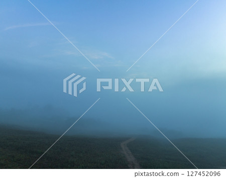 Aerial view mist cover the forest in the valley. Aerial view mist cover the forest in the valley. 127452096