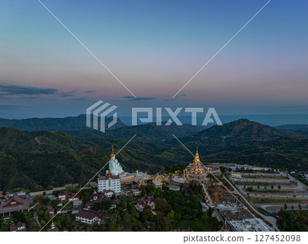 Aerial view White buddha in Wat Phra That Pha Son Kaew temple at sunset. Aerial view White buddha in Wat Phra That Pha Son Kaew temple at sunset. 127452098