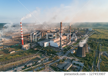 Air pollution from industrial facilities causes environmental concerns in urban areas during sunset hours. Air pollution from industrial facilities causes environmental concerns in urban areas during sunset hours. 127453907