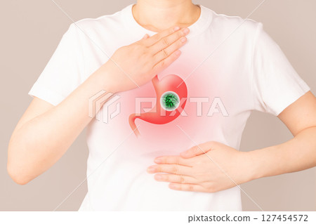 Woman suffering from heartburn and stomachache. Helicobacter pylori bacteria infects human stomach. H.pylori infections may result in stomach inflammation (gastritis) and peptic ulcer disease. Woman suffering from heartburn and stomachache. Helicobacter pylori bacteria infects human stomach. H.pylori infections may result in stomach inflammation (gastritis) and peptic ulcer disease. 127454572