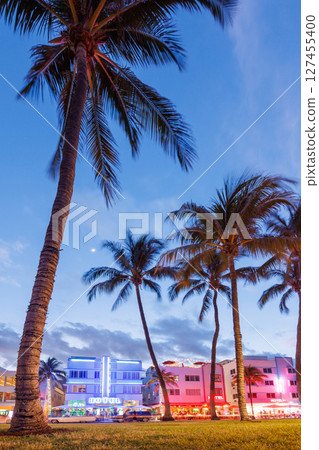 Colorful Art Deco hotels on Ocean Drive in Miami Beach glow under the warm hues of a vibrant sunset Colorful Art Deco hotels on Ocean Drive in Miami Beach glow under the warm hues of a vibrant sunset 127455400