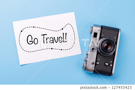 Travel-themed flat lay with card and camera 127455423