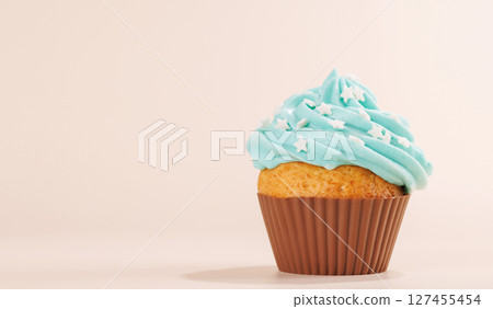 Festive cupcake topped with swirled frosting Festive cupcake topped with swirled frosting 127455454