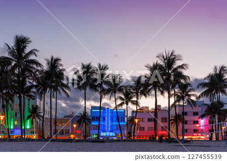 Colorful Art Deco hotels on Ocean Drive in Miami Beach glow under the warm hues of a vibrant sunset Colorful Art Deco hotels on Ocean Drive in Miami Beach glow under the warm hues of a vibrant sunset 127455539