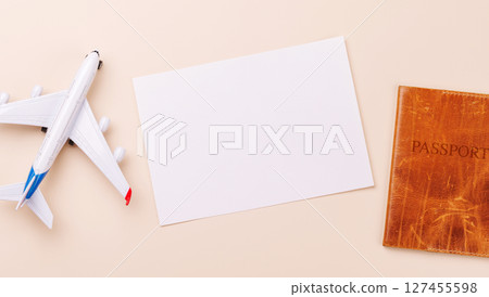 Travel-themed flat lay with blank photo card, passport, toy airplane Travel-themed flat lay with blank photo card, passport, toy airplane 127455598