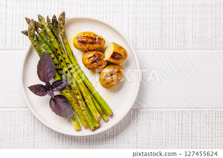 Grilled asparagus and golden baby potatoes Grilled asparagus and golden baby potatoes 127455624