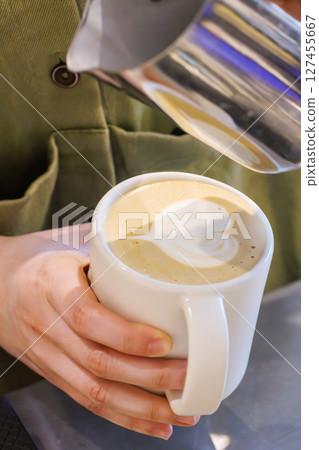 Barista crafting cappuccino with heart-shaped latte art Barista crafting cappuccino with heart-shaped latte art 127455667