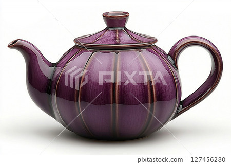 Ceramic teapot in shape of a purple eggplant in a rustic style on a white background. Ceramic teapot in shape of a purple eggplant in a rustic style on a white background. 127456280