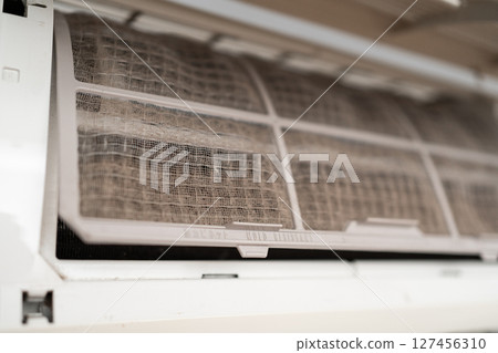 Dirty in dust and mold air conditioner filter close-up. Home air conditioner maintenance Dirty in dust and mold air conditioner filter close-up. Home air conditioner maintenance 127456310