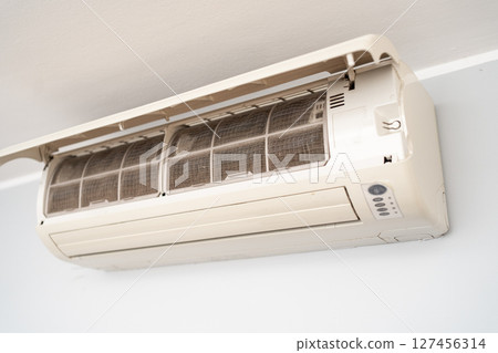 Dirty in dust and mold air conditioner filter close-up. Home air conditioner maintenance Dirty in dust and mold air conditioner filter close-up. Home air conditioner maintenance 127456314