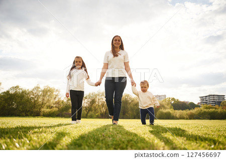 Woman with her two young daughters is on the summer field 127456697