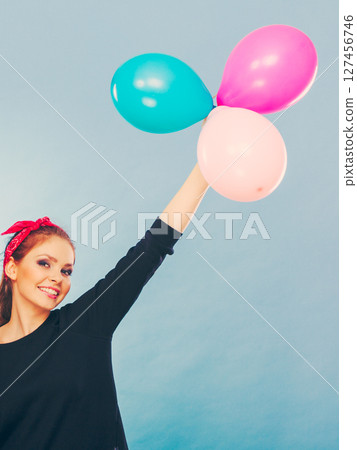 Lovely smiling girl holds colorful balloons. Lovely smiling girl holds colorful balloons. 127456746