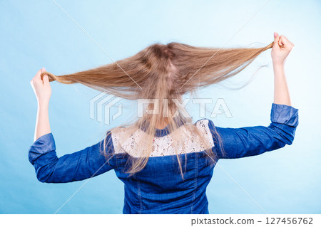 Blonde woman playing with hair. Blonde woman playing with hair. 127456762
