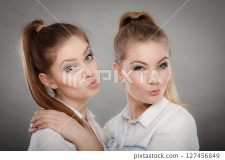 Lovely playful sisters women portrait. 127456849